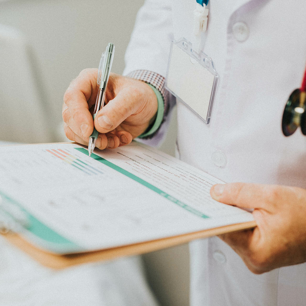 Physician noting down symptoms of a patient